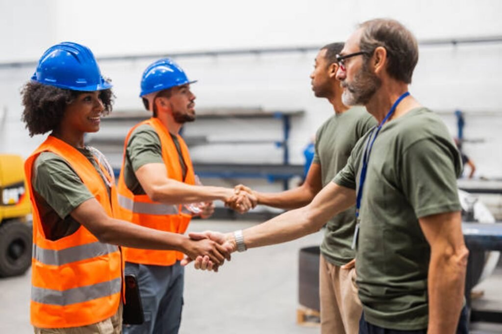 Tree service professionals shaking hands with clients during a project discussion in Macedonia, OH